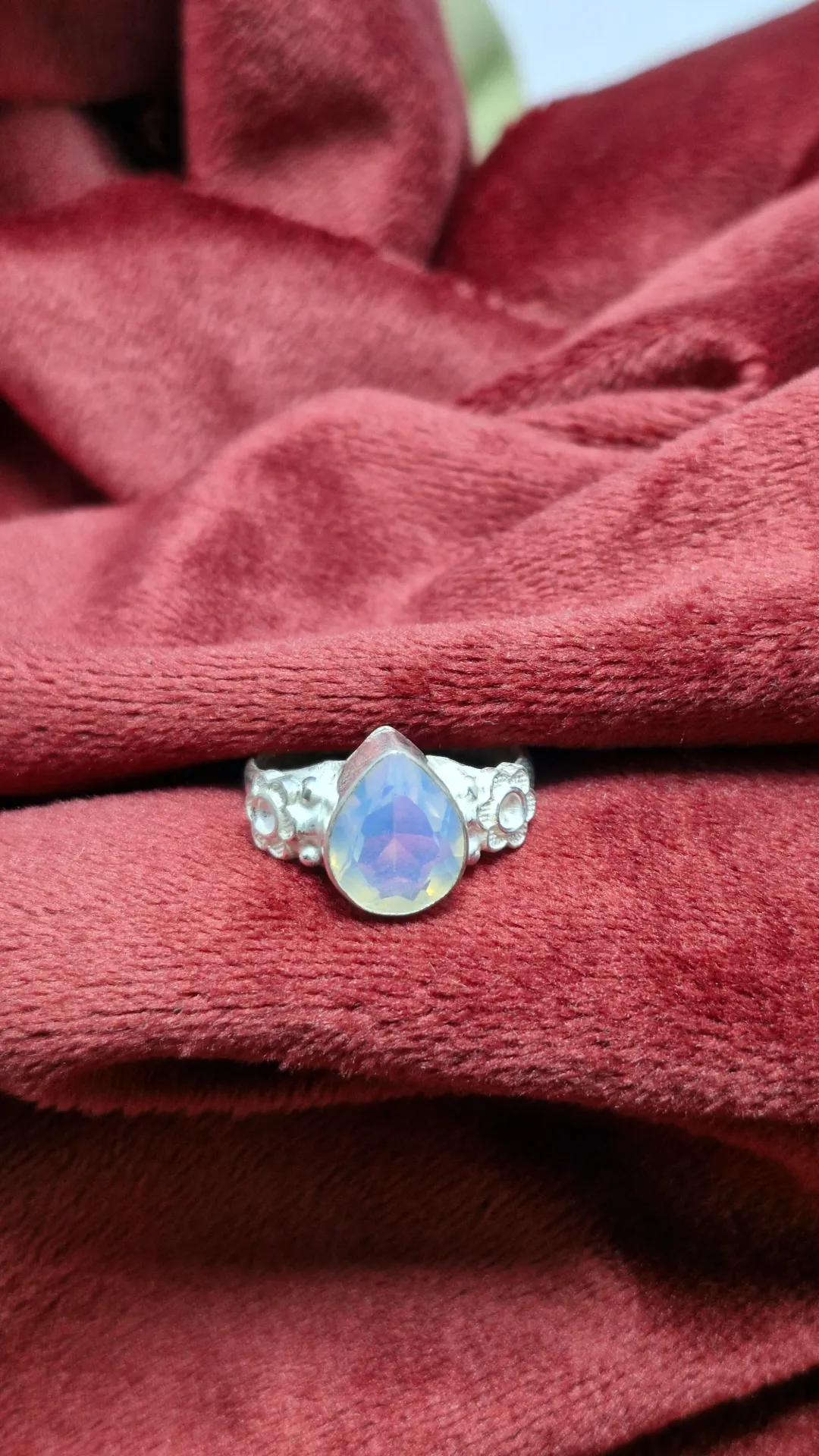 sterling silver ring with a pear-shaped rainbow moonstone